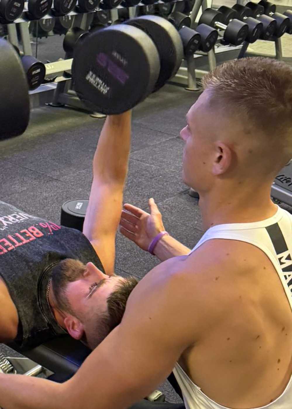 Personal training session coaching a bench press at the gym